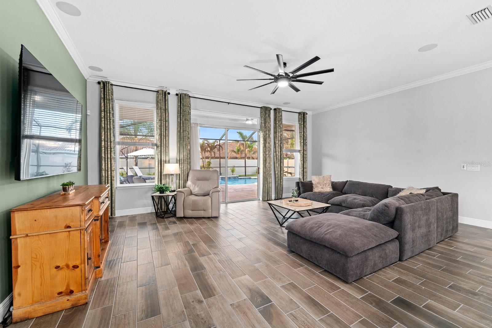 family room with a pool view