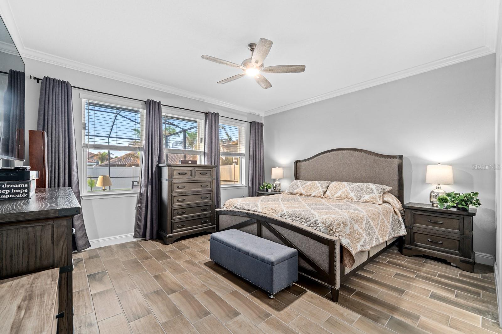 Primary bedroom with a pool view