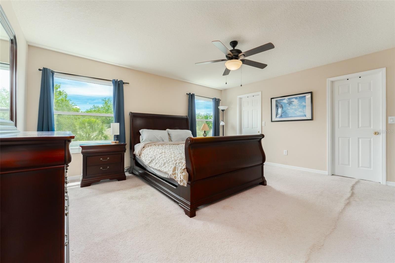 primary bedroom with dual walk-in closets