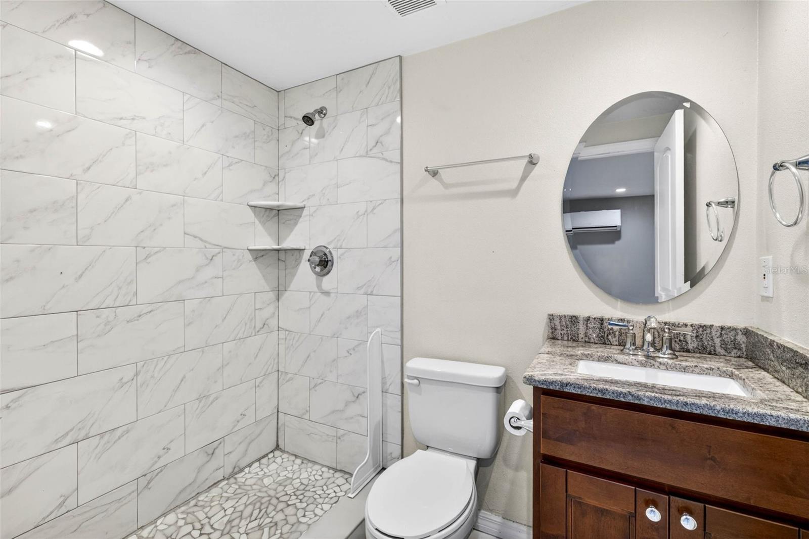 Guest apartment bathroom with floor to ceiling tile