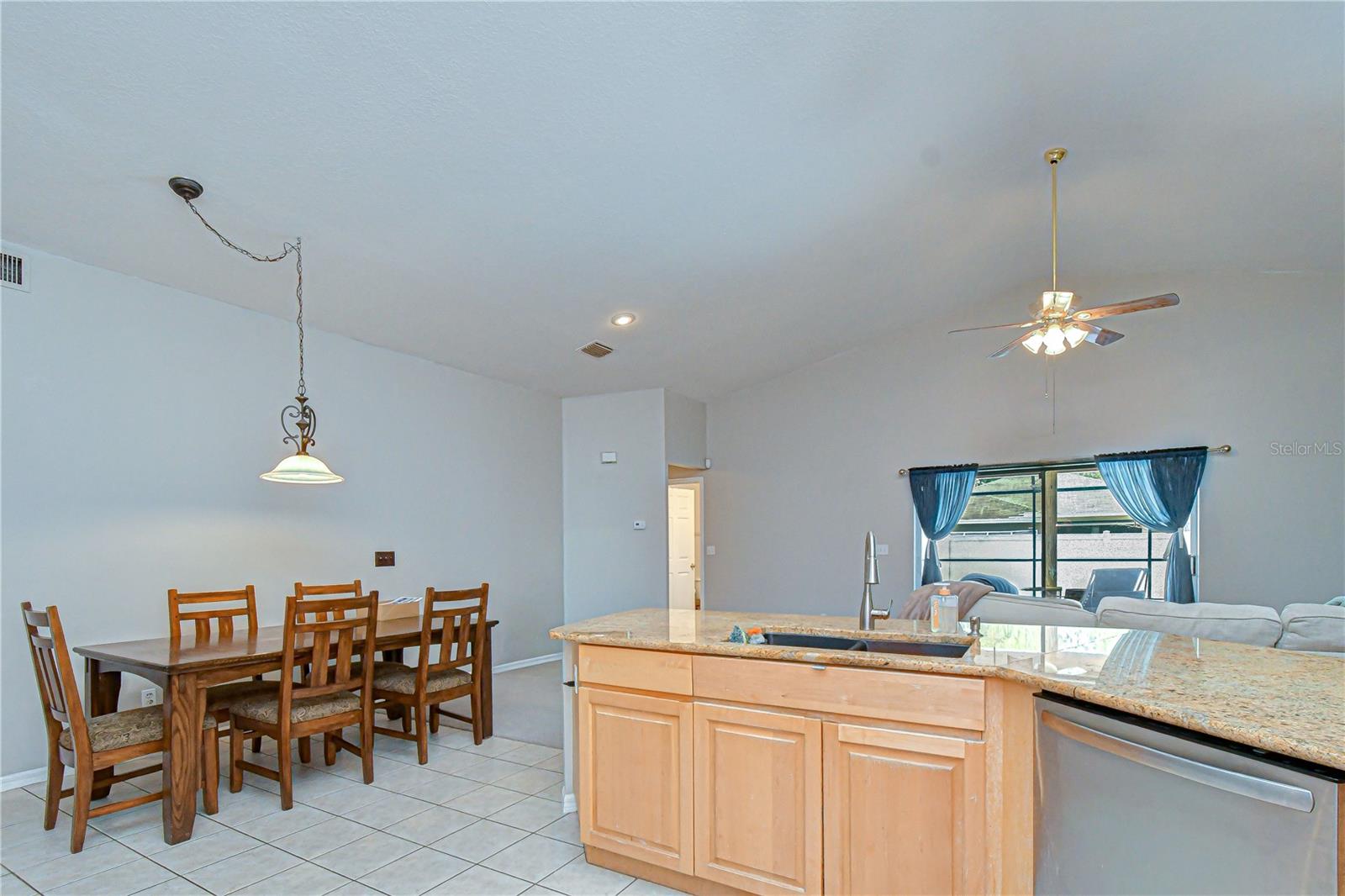 Open connection to surrounding living and dining spaces
