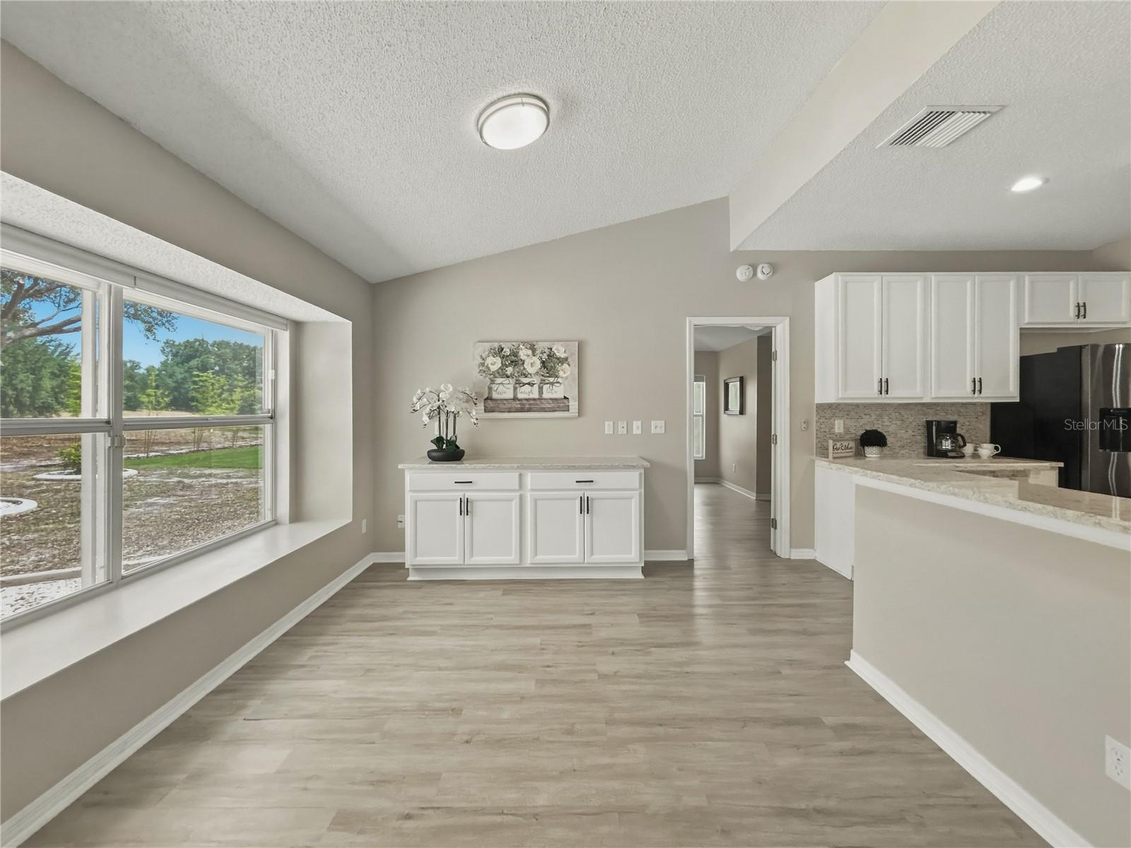 Eat in kitchen area with ample room for barstools and a path for a walk-way