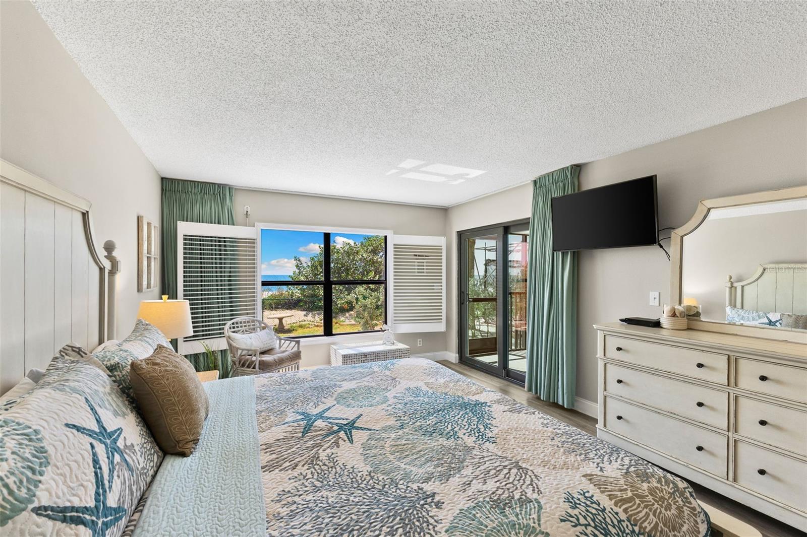 Primary Bedroom has access to screened-in lanai