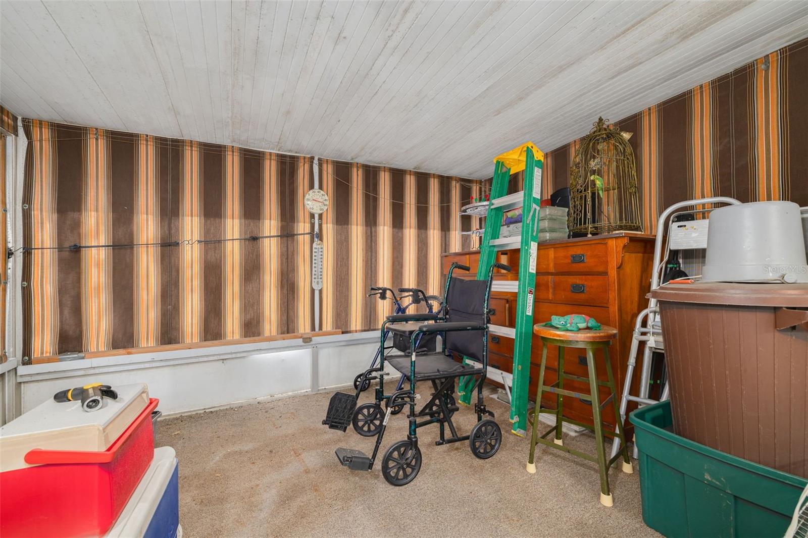 Large Florida Room with sun shades, htat leads out to your private backyard space.
