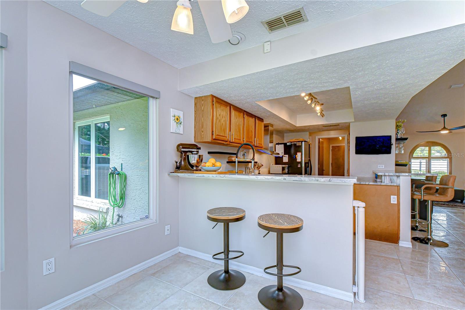 Custom lighting enhancing the kitchen space with Breakfast Bar