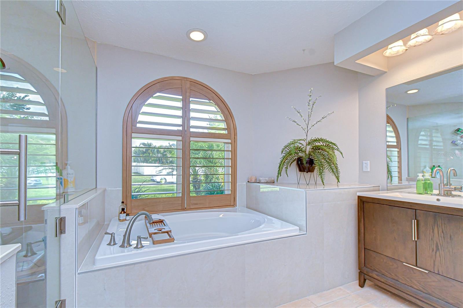 Luxurious tub with elegant shutters adding style and privacy