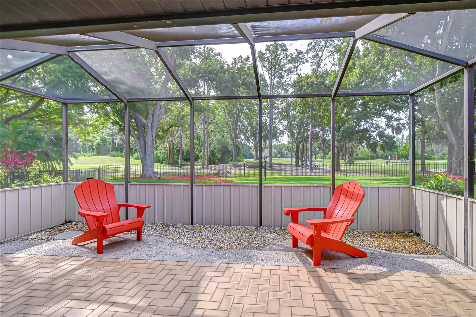 Covered outdoor living space overlooking golf course