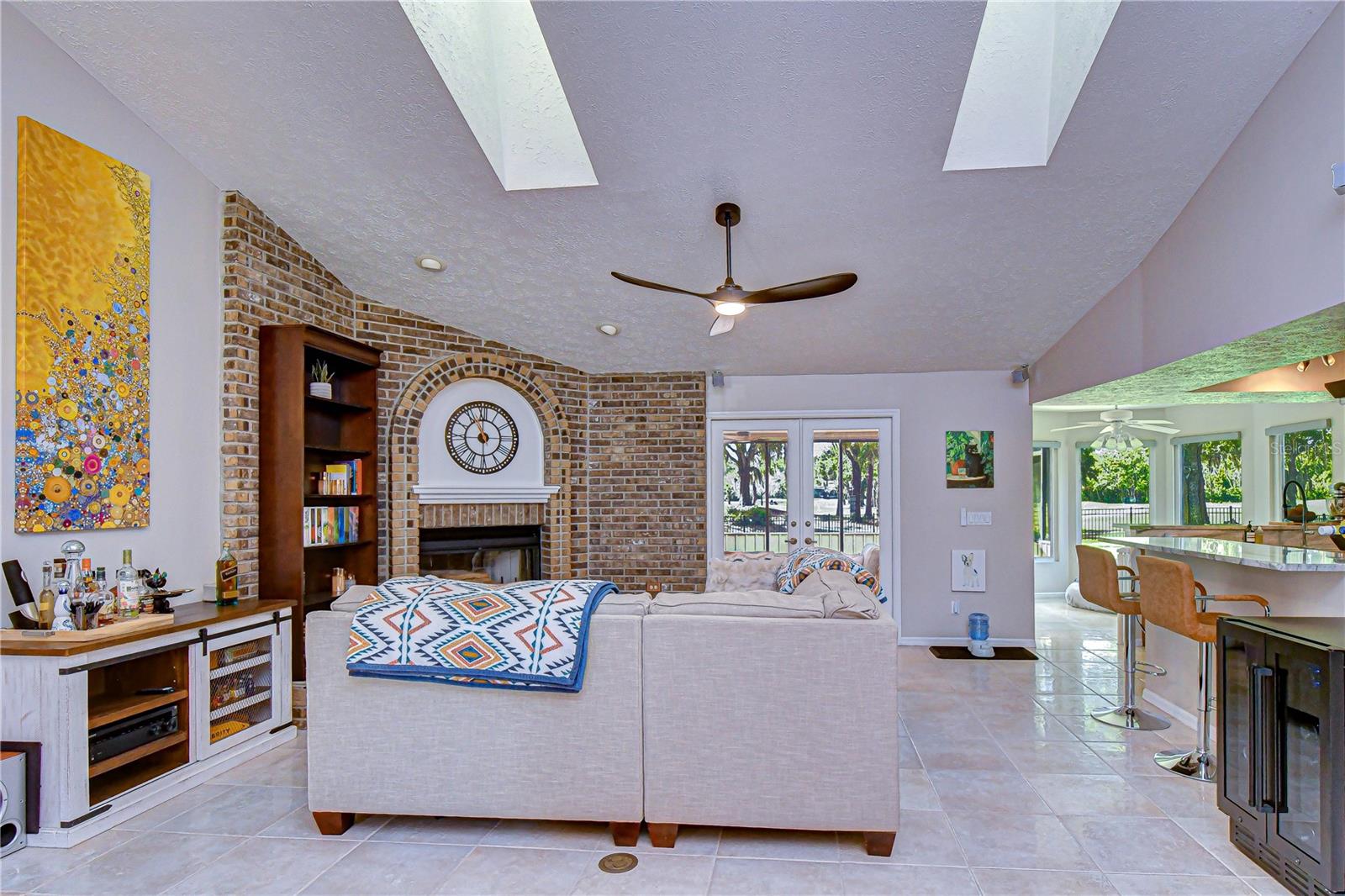 Spacious gathering area centered around a brick wood-burning fireplace