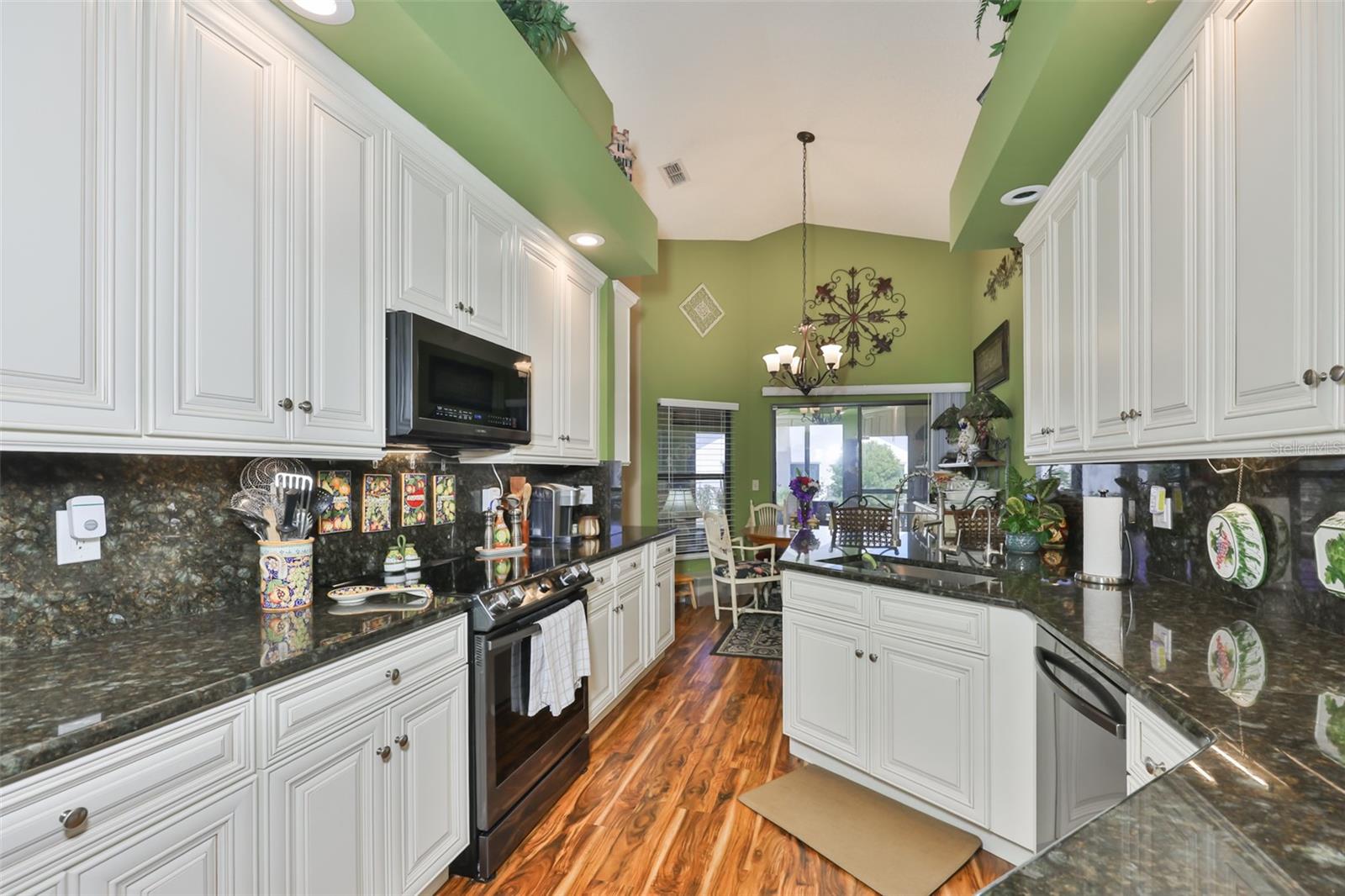 Gorgeous Remodeled Kitchen, White Cabinets, Black SS Appliances, Full Height Granite Back Splash, Acacia Flooring, Eat-In Kitchen Space