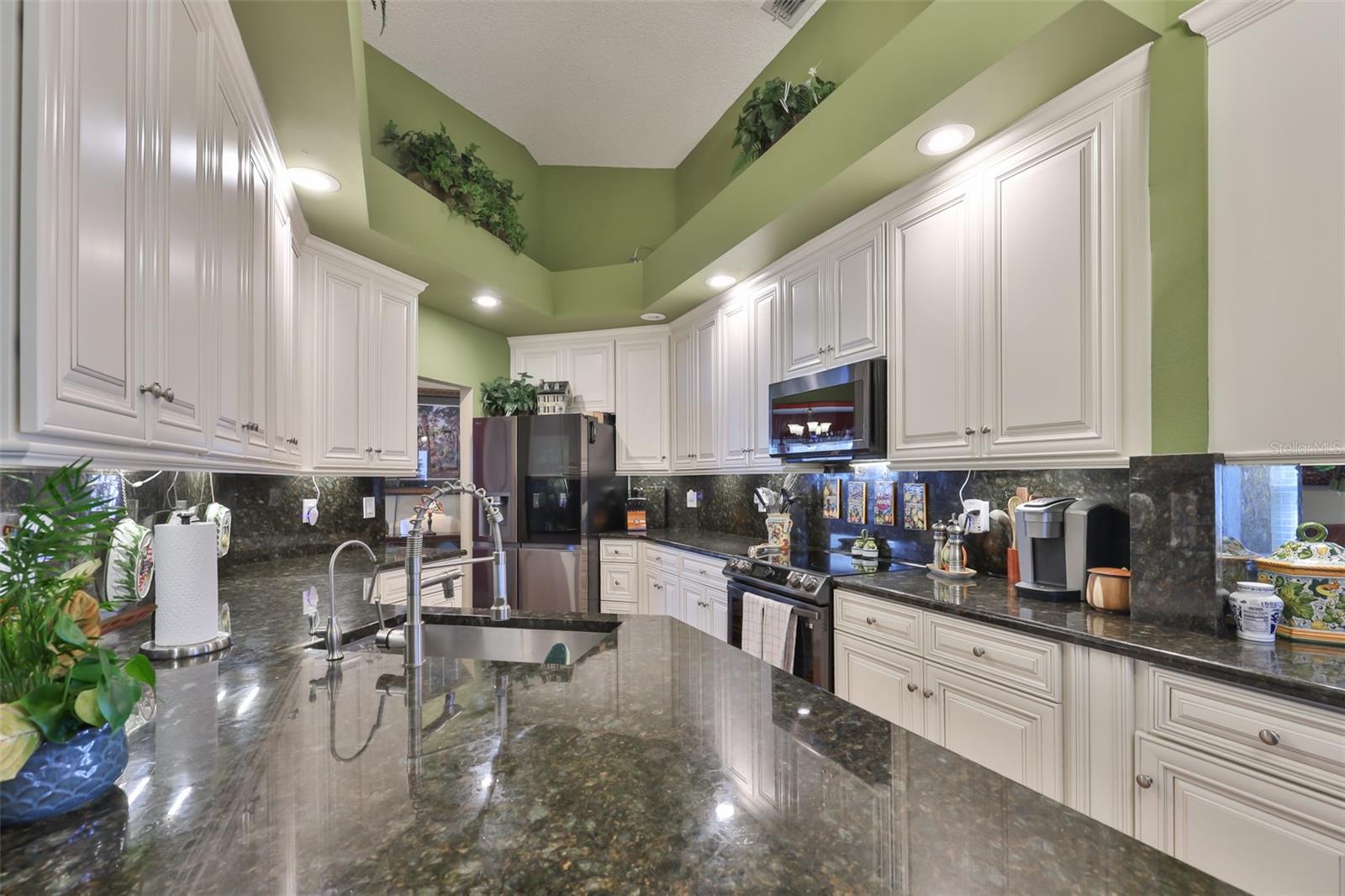 White Cabinets, Black SS Appliances, Exquisite Granite Countertop w/ Full-Height Granite Backsplash, Beautiful Acacia Flooring