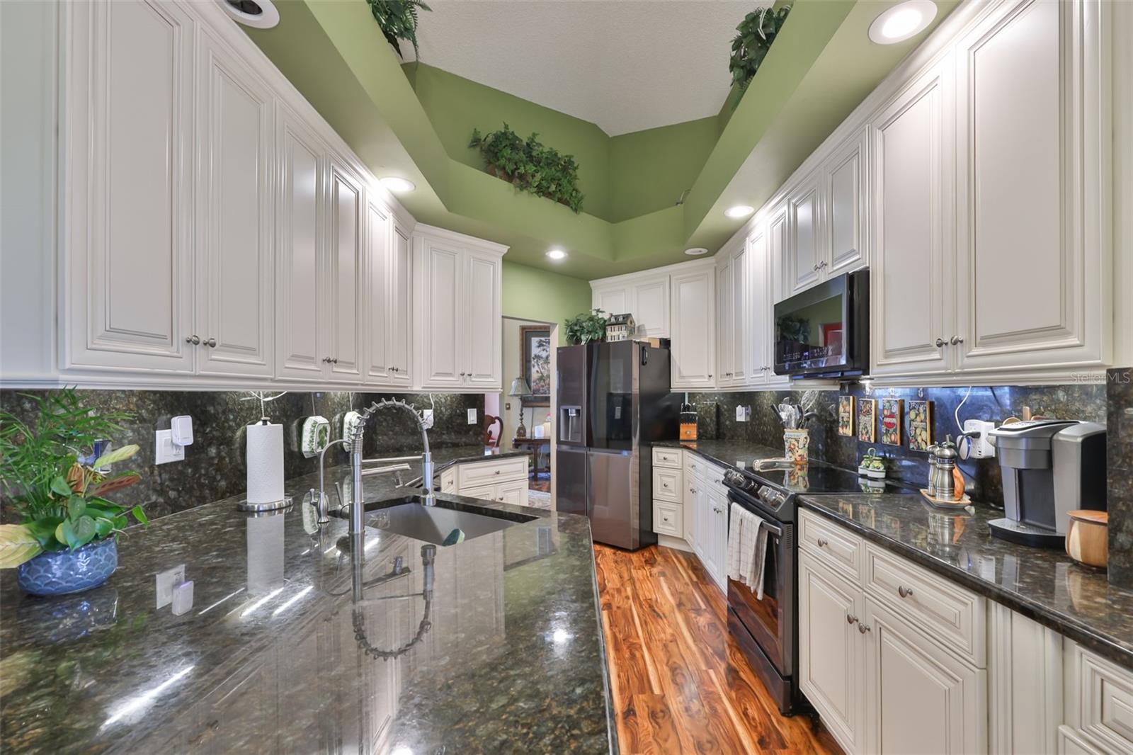 White Cabinets, SS Appliances, Exquisite Granite Countertop & Backsplash, Beautiful Acacia Wood Flooring