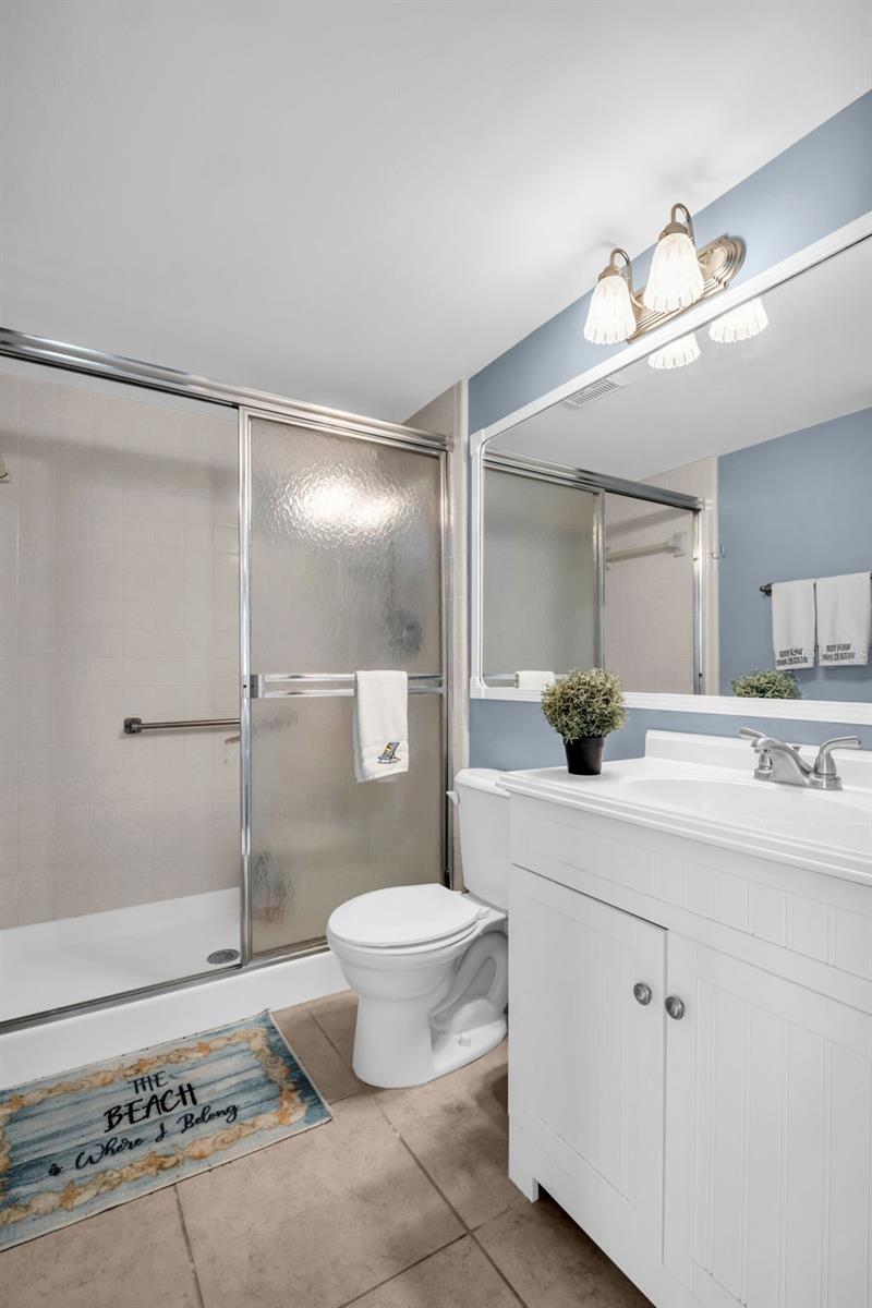 Primary en-suite with updated vanity and conveniently walk-in shower~
