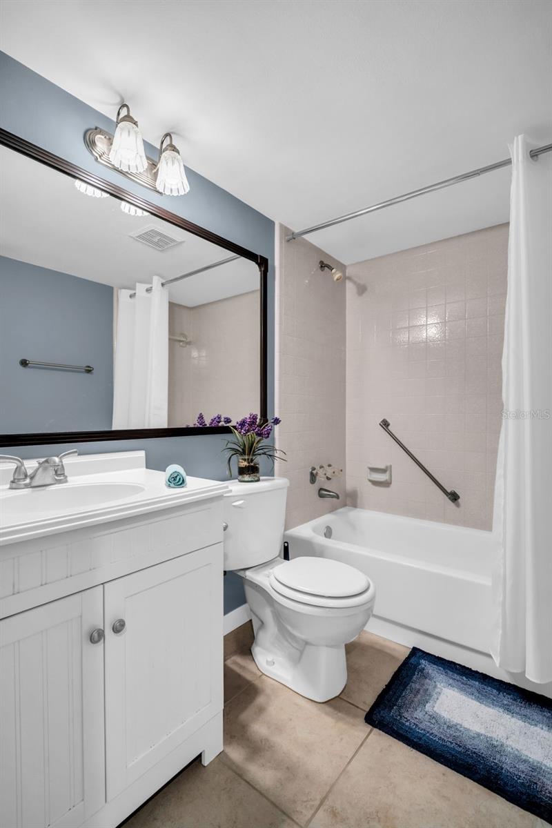 Beautiful hall bath with newer vanity, tub/shower combo, and perfectly located adjacent from the 2nd bedroom~