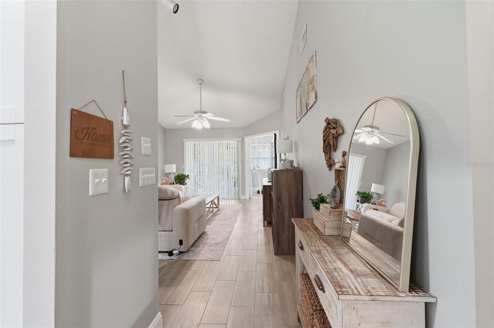 Family room, with tall ceilings and ceiling fan.