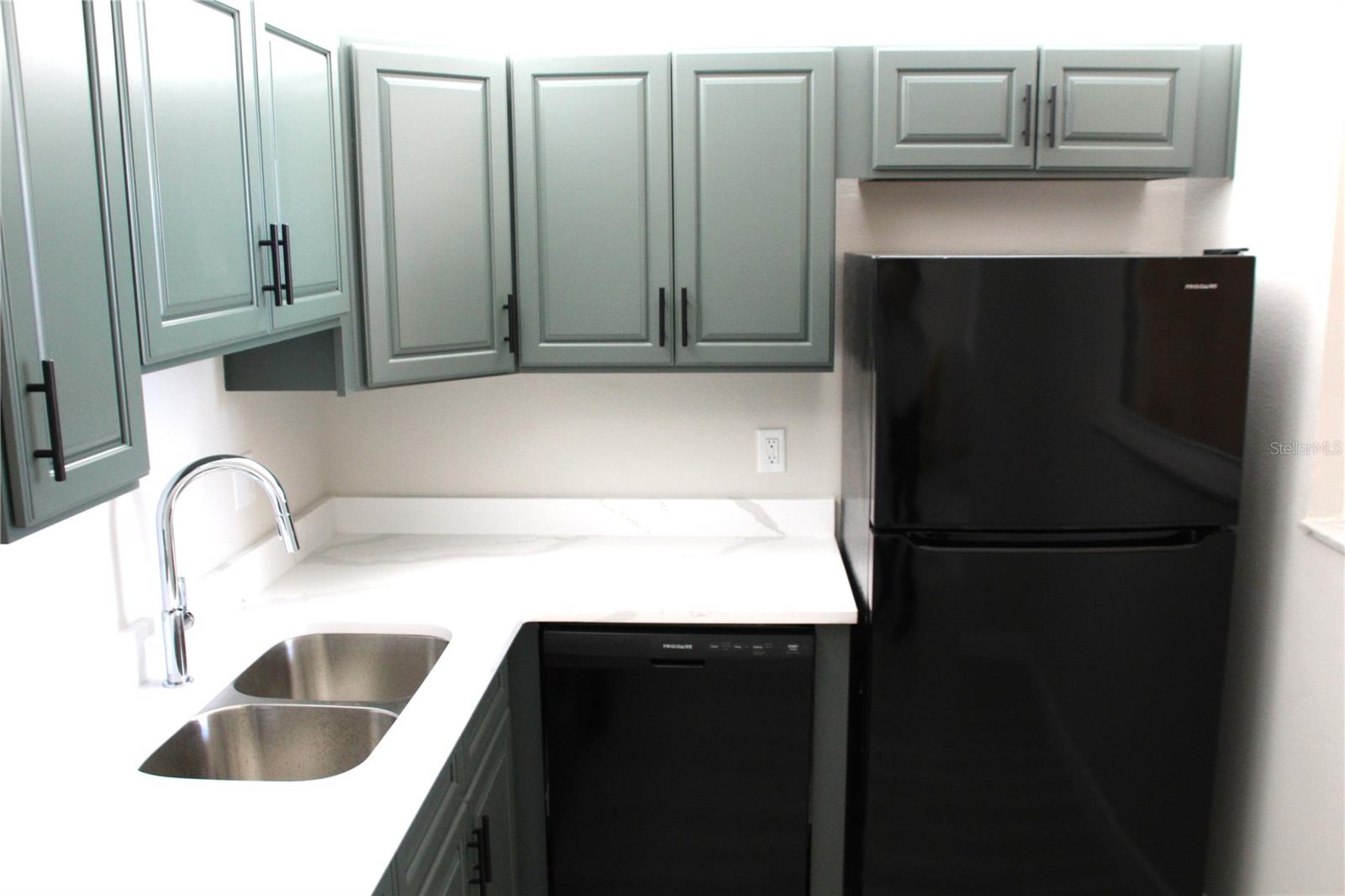 The kitchen is enhanced by double sinks, offering both practicality and a touch of modern convenience