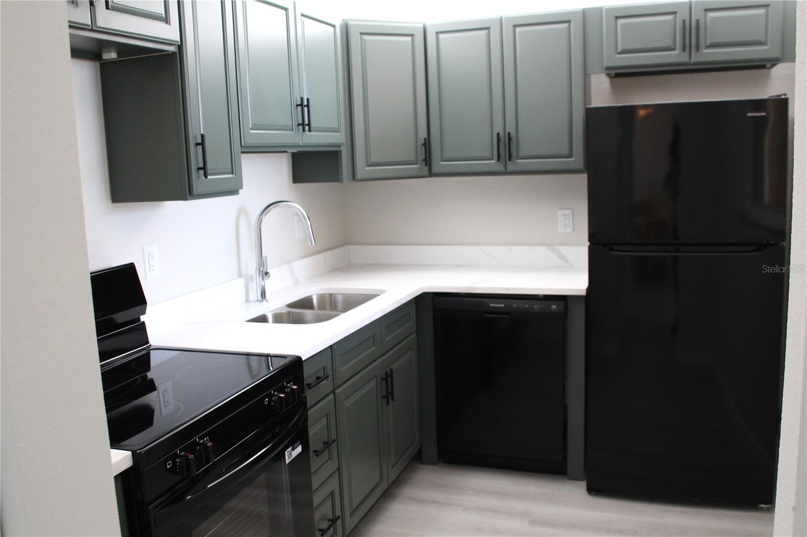 A beautifully refreshed kitchen showcases brand-new cabinetry and appliances, creating a bright, functional space for everyday living
