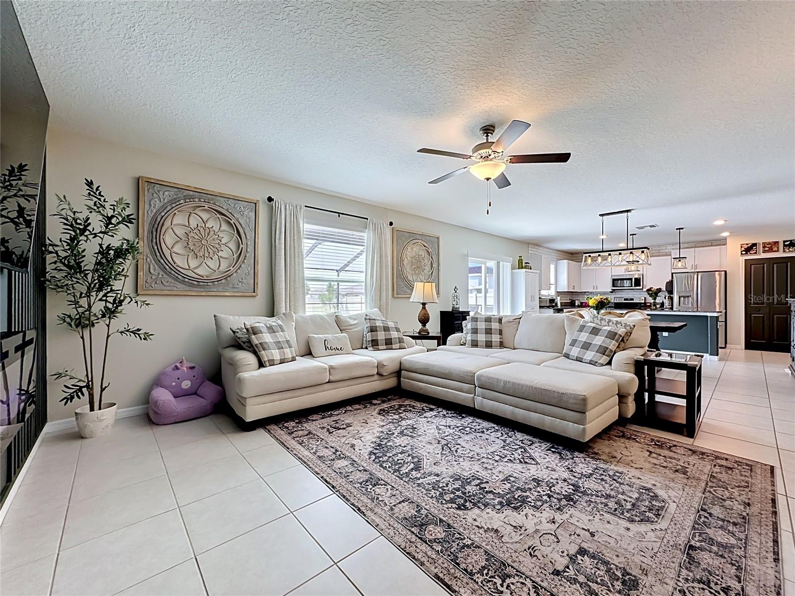 Spacious living room with custom accent wall and electric fireplace