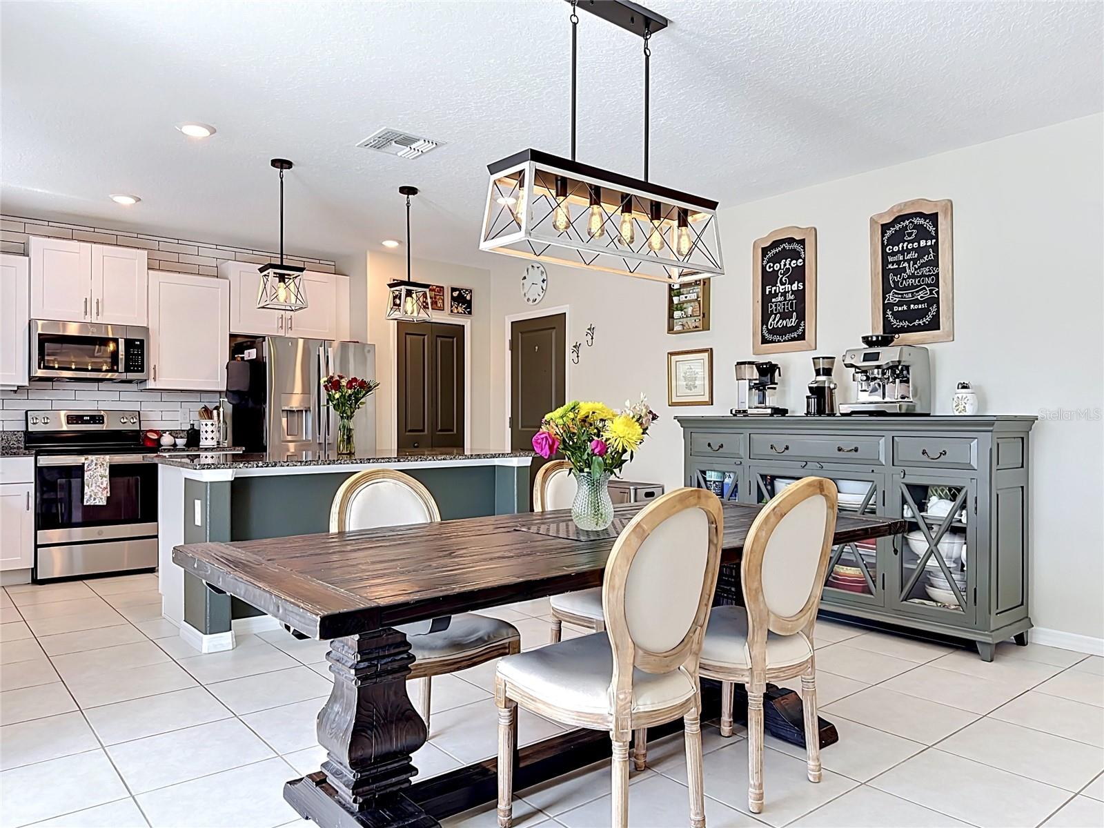 Beautiful kitchen and dining area with updated lighting and modern finishes