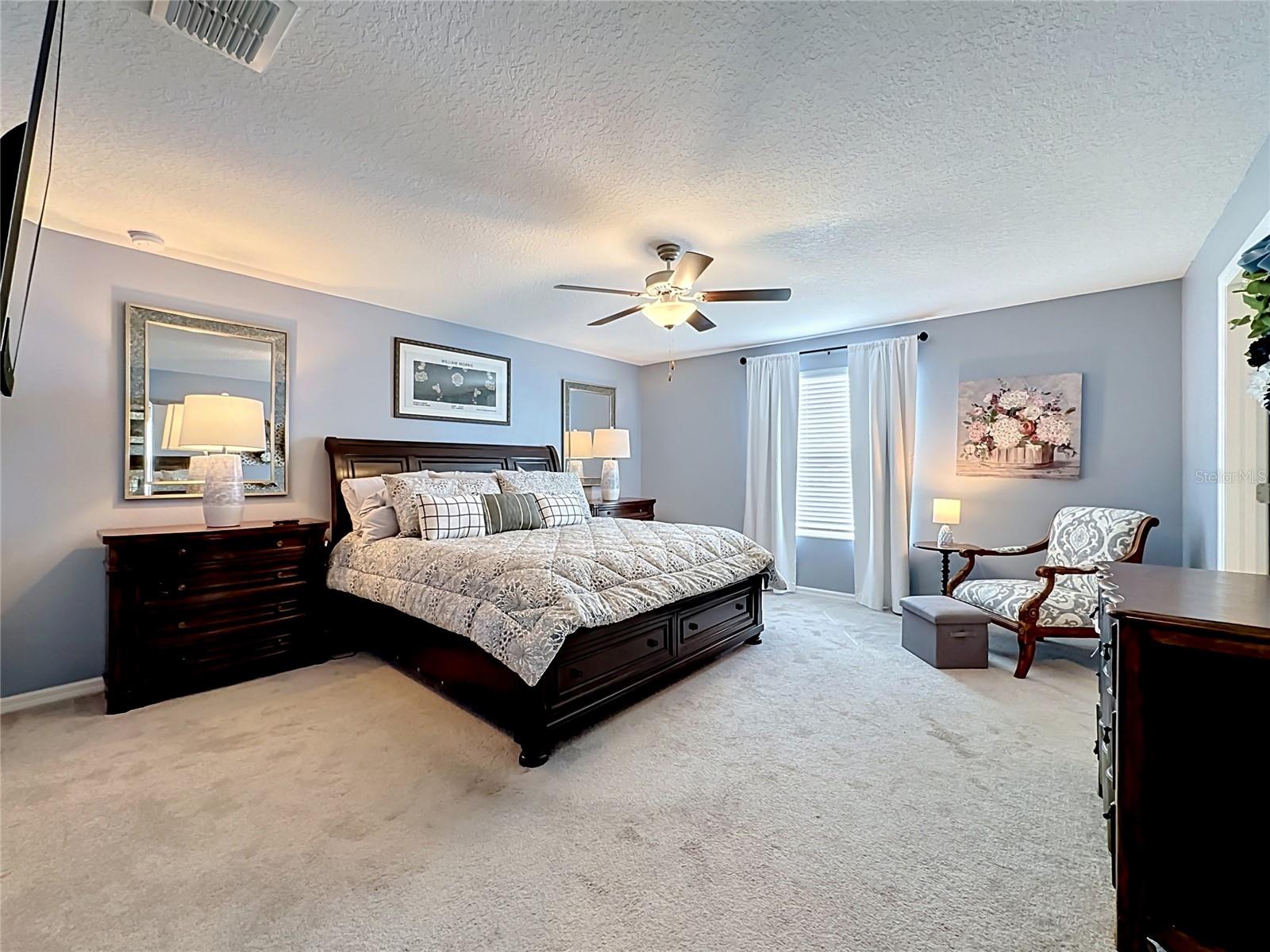 Private primary bedroom retreat with en-suite bathroom and oversized walk-in closet