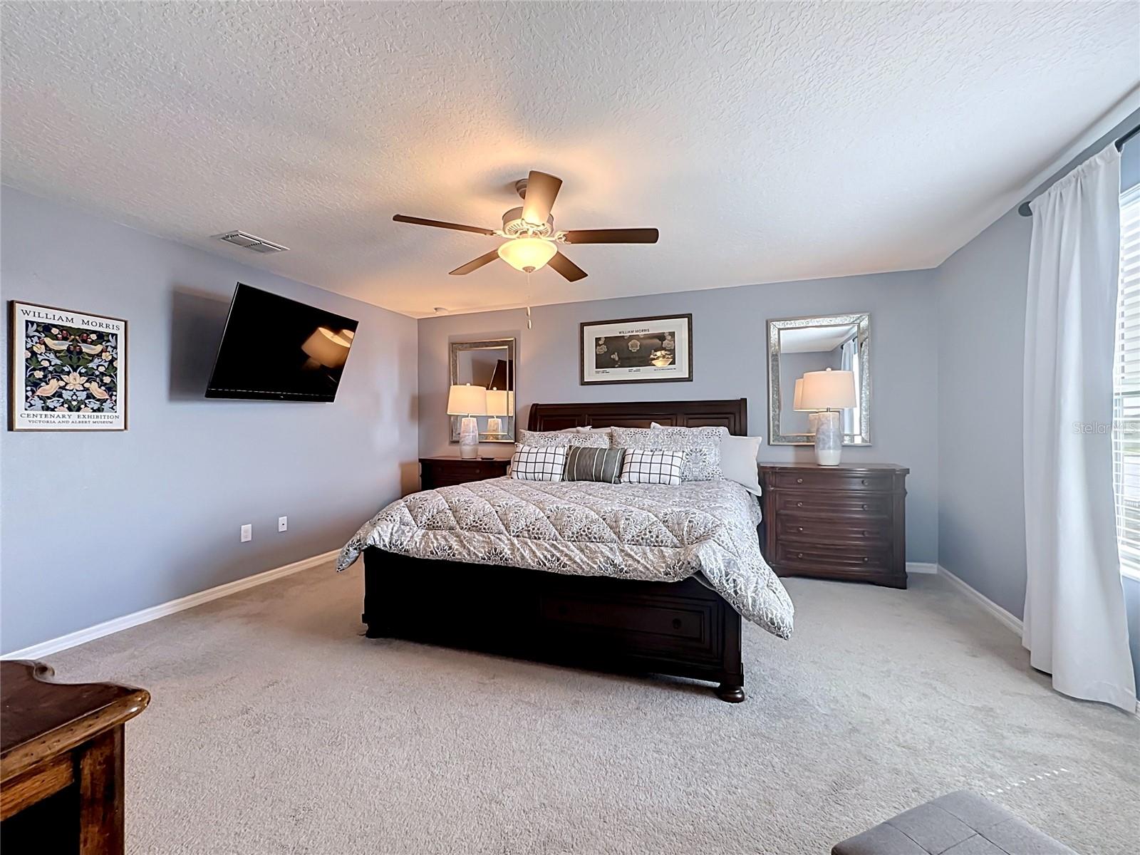 Private primary bedroom retreat with en-suite bathroom and oversized walk-in closet