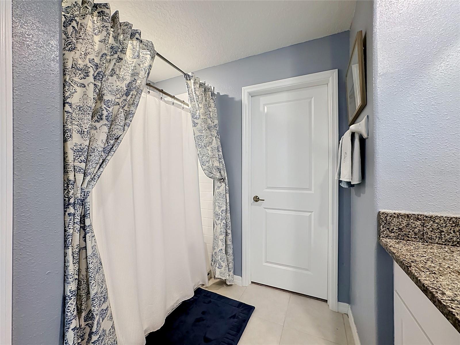 Primary en-suite bathroom with dual sink vanity and step-in shower