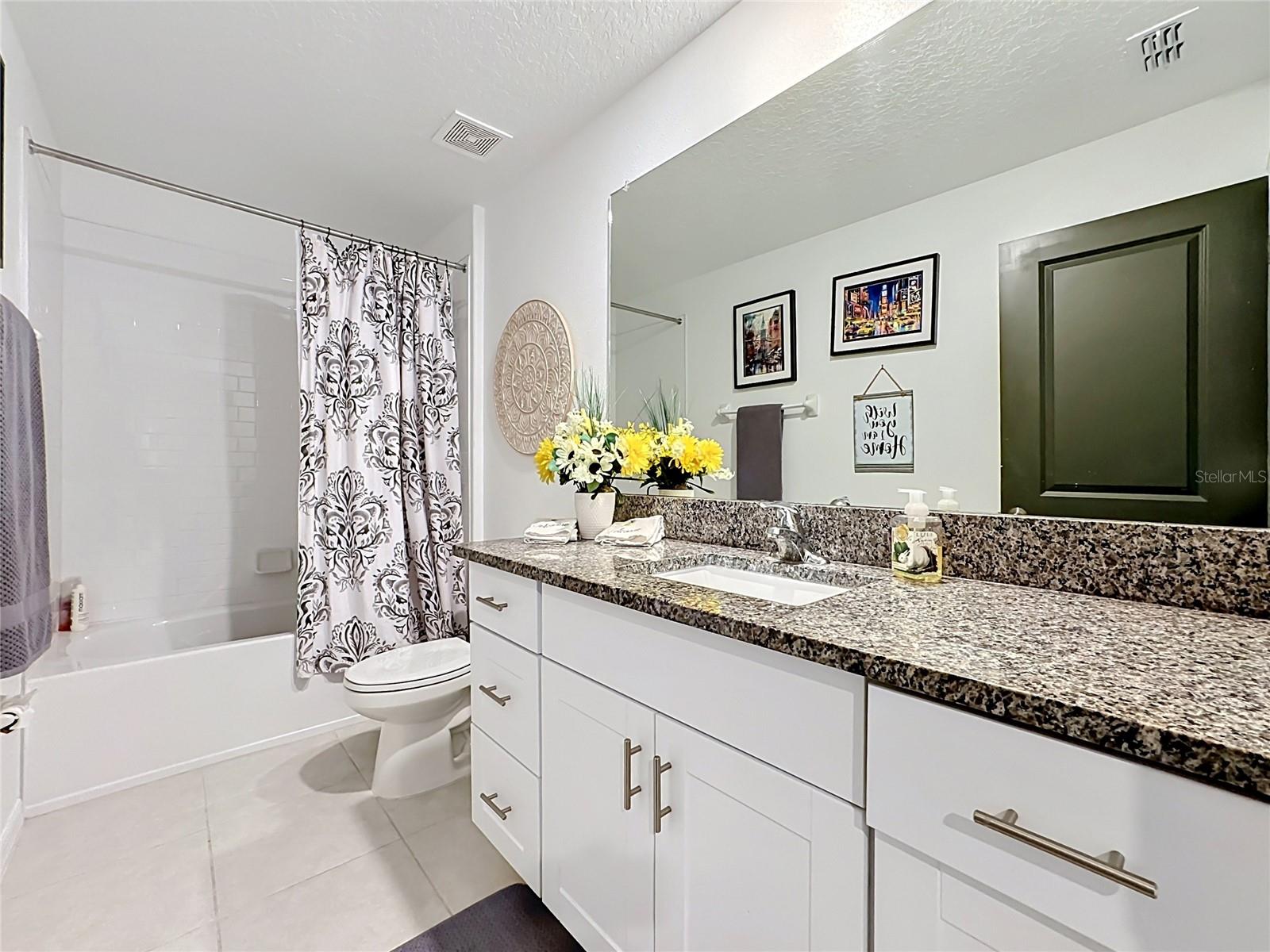 Bathroom 2 with granite vanity and tub/shower combination