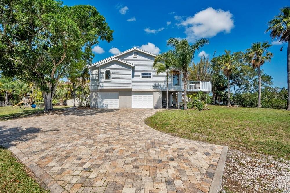 Elevated living space stayed dry during recent storms, paver driveway allows for plenty of parking and yard has room for pool and extra space for boats or RVs