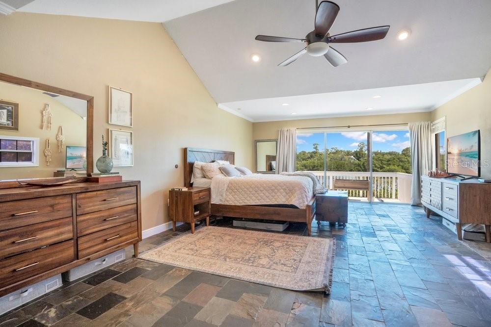 Oversized primary bedroom with open balcony