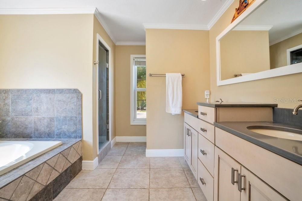Primary w dual vanity, garden tub, and separate shower