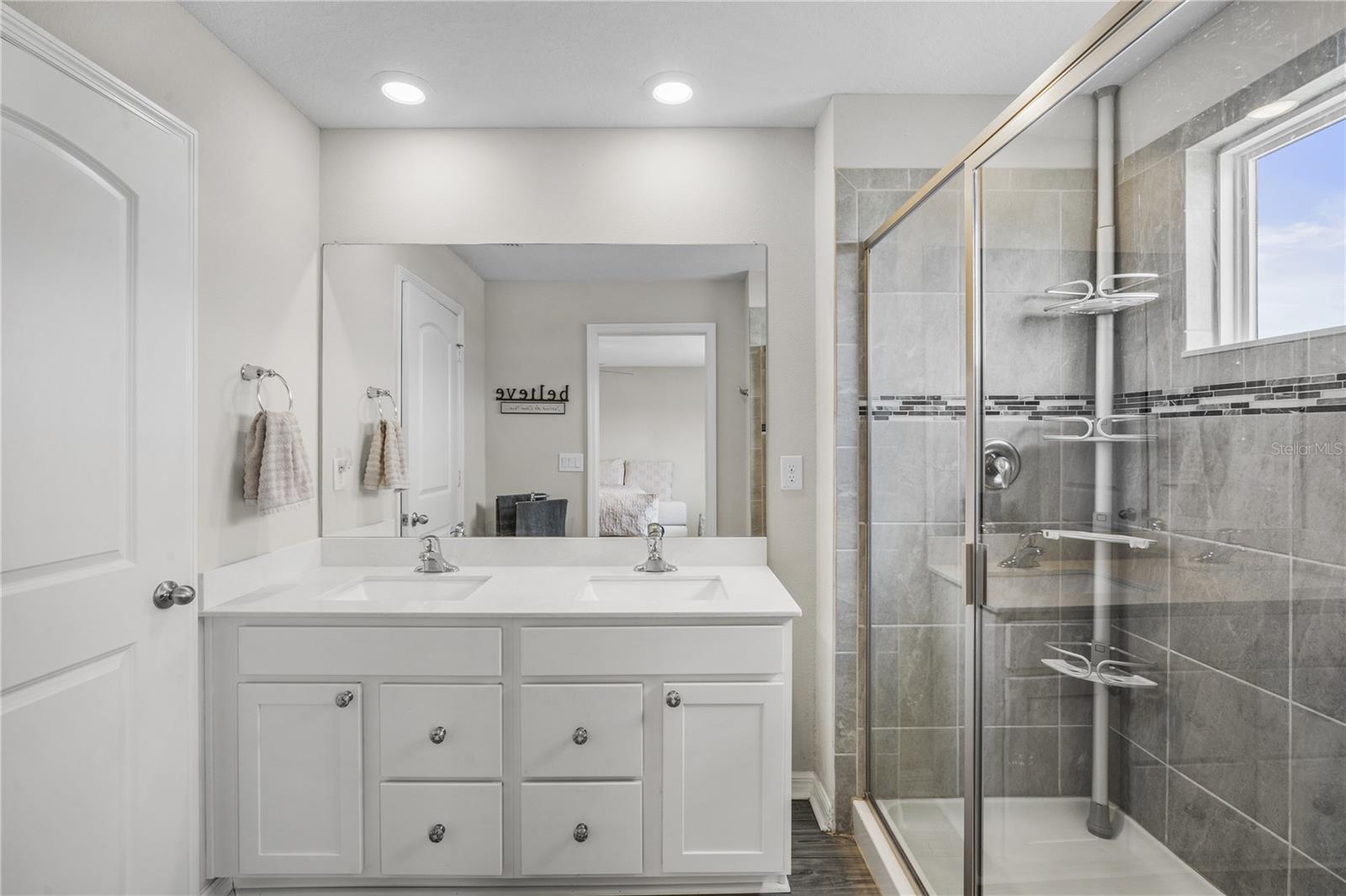 Bath ensuite with large shower and dual sinks
