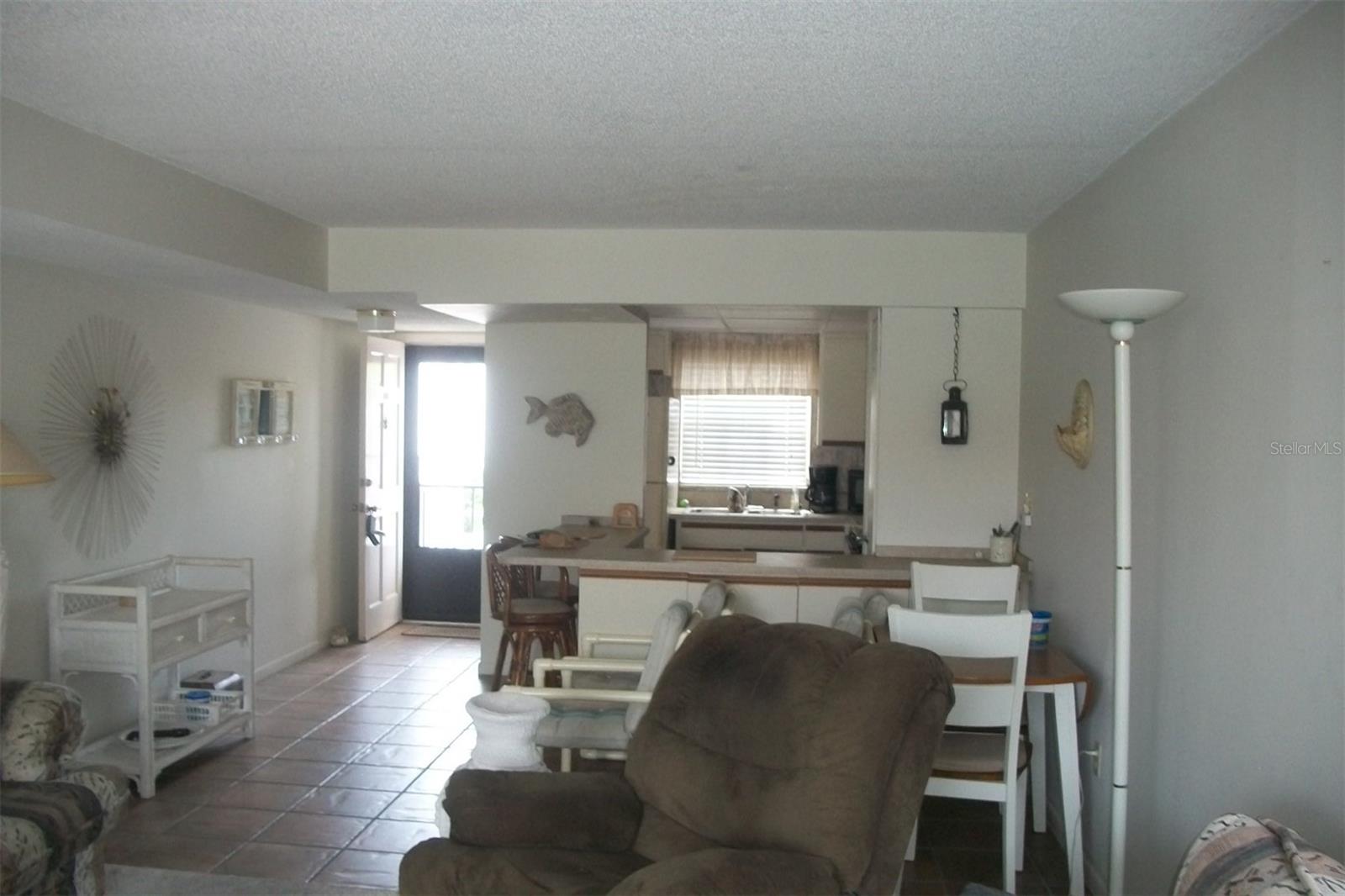 Standing in Living room looking into Kitchen, Kitchen has breakfast bar