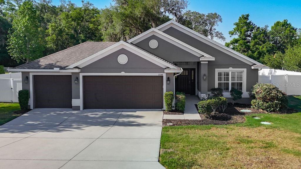 Single-story residence offering timeless curb appeal with its modern gray exterior, crisp white trim, and inviting entryway