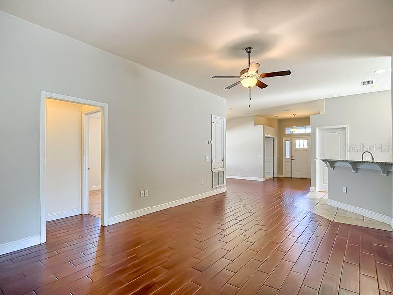 Living room looking back towards foyer, dining room, and kitchen