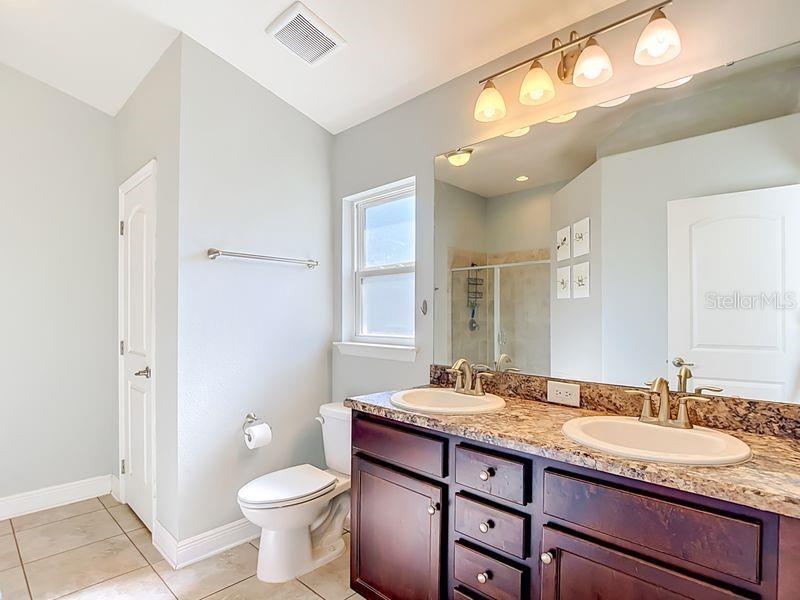 Elegant primary bathroom featuring dual-sink vanity.
