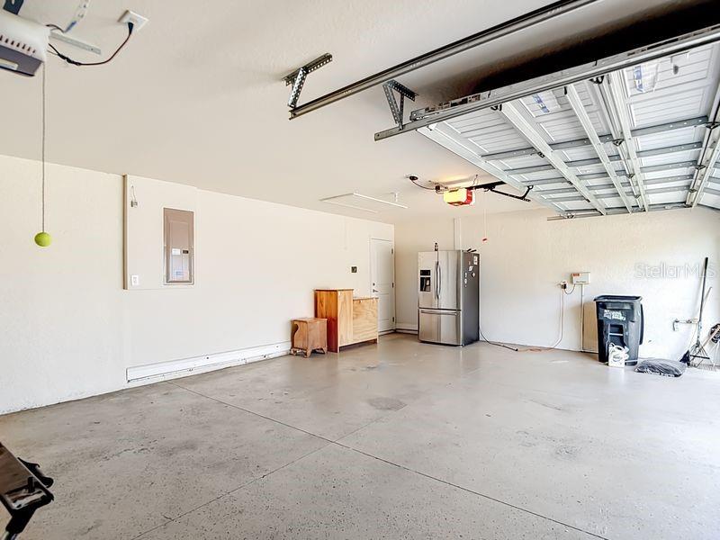 Three car garage offering ample room for vehicles, storage, or a workshop setup