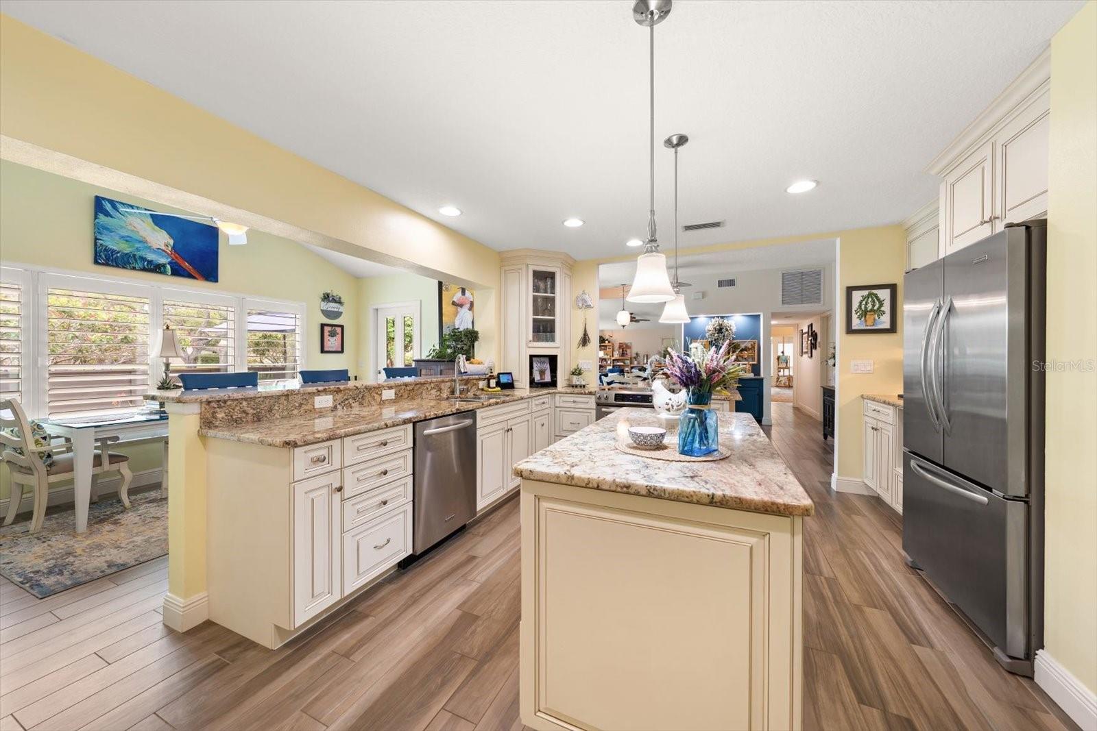 Fully equipped kitchen with  Kitchen Aid Stainless appliances, extensive custom cabinetry, and attractive granite counters