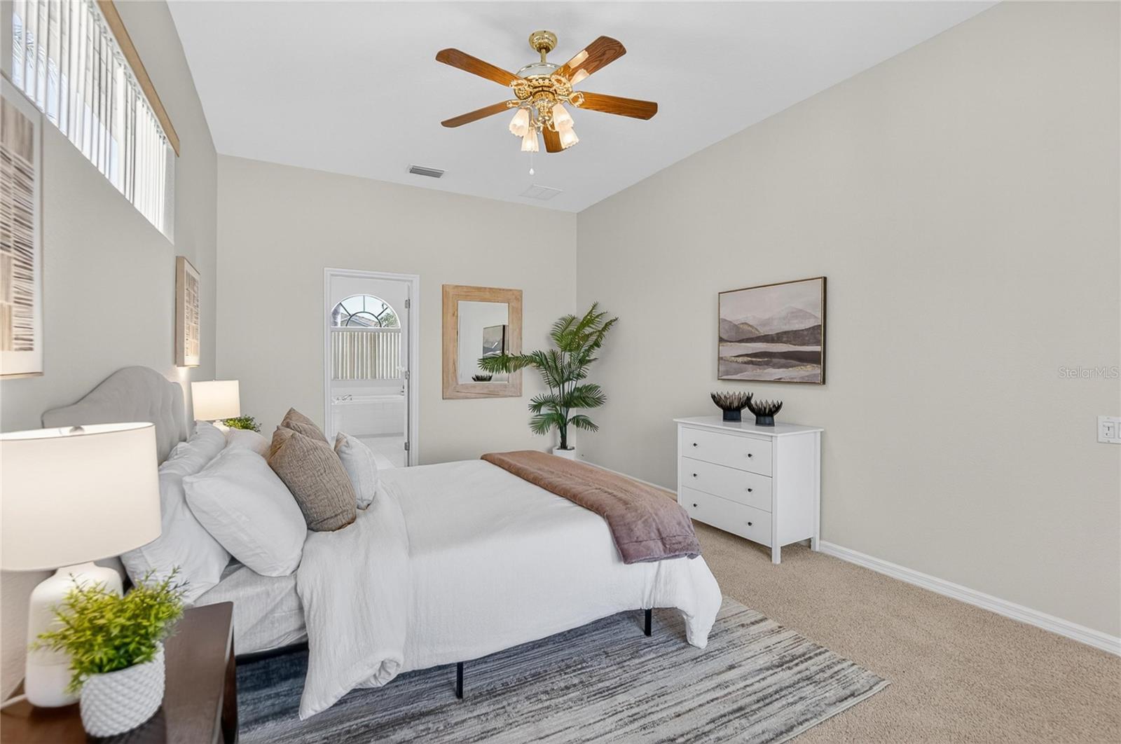 Primary bedroom has an overhead fan