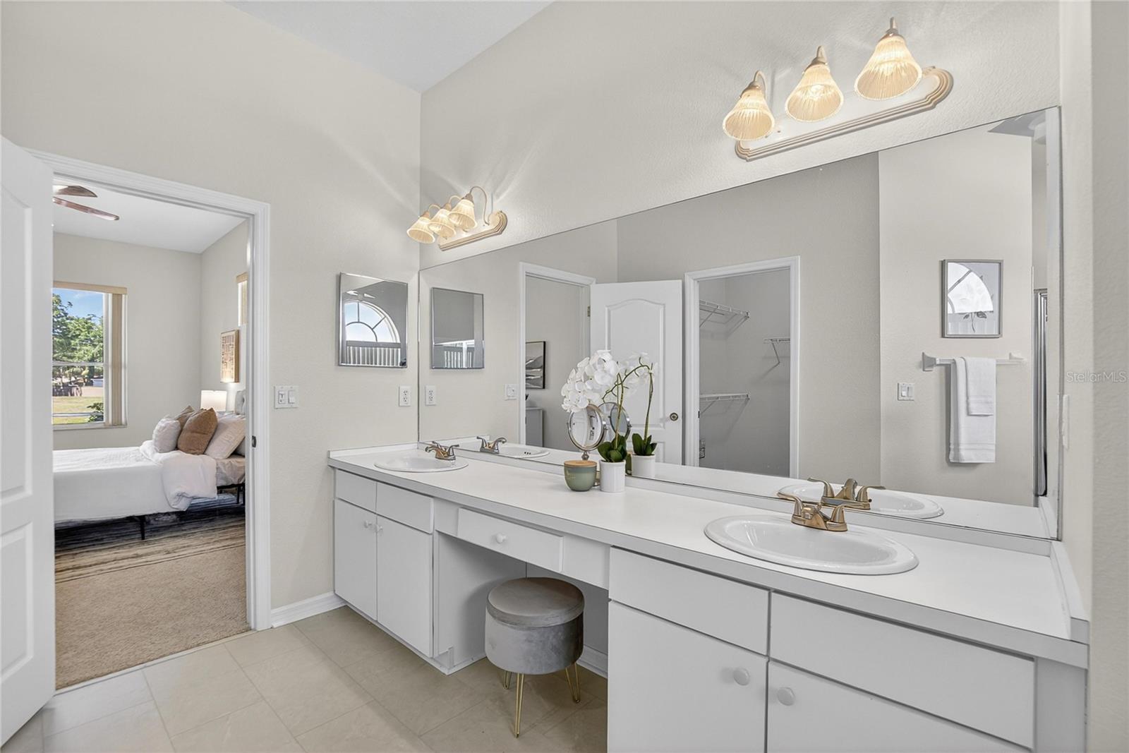 A makeup vanity space in place between the double sinks