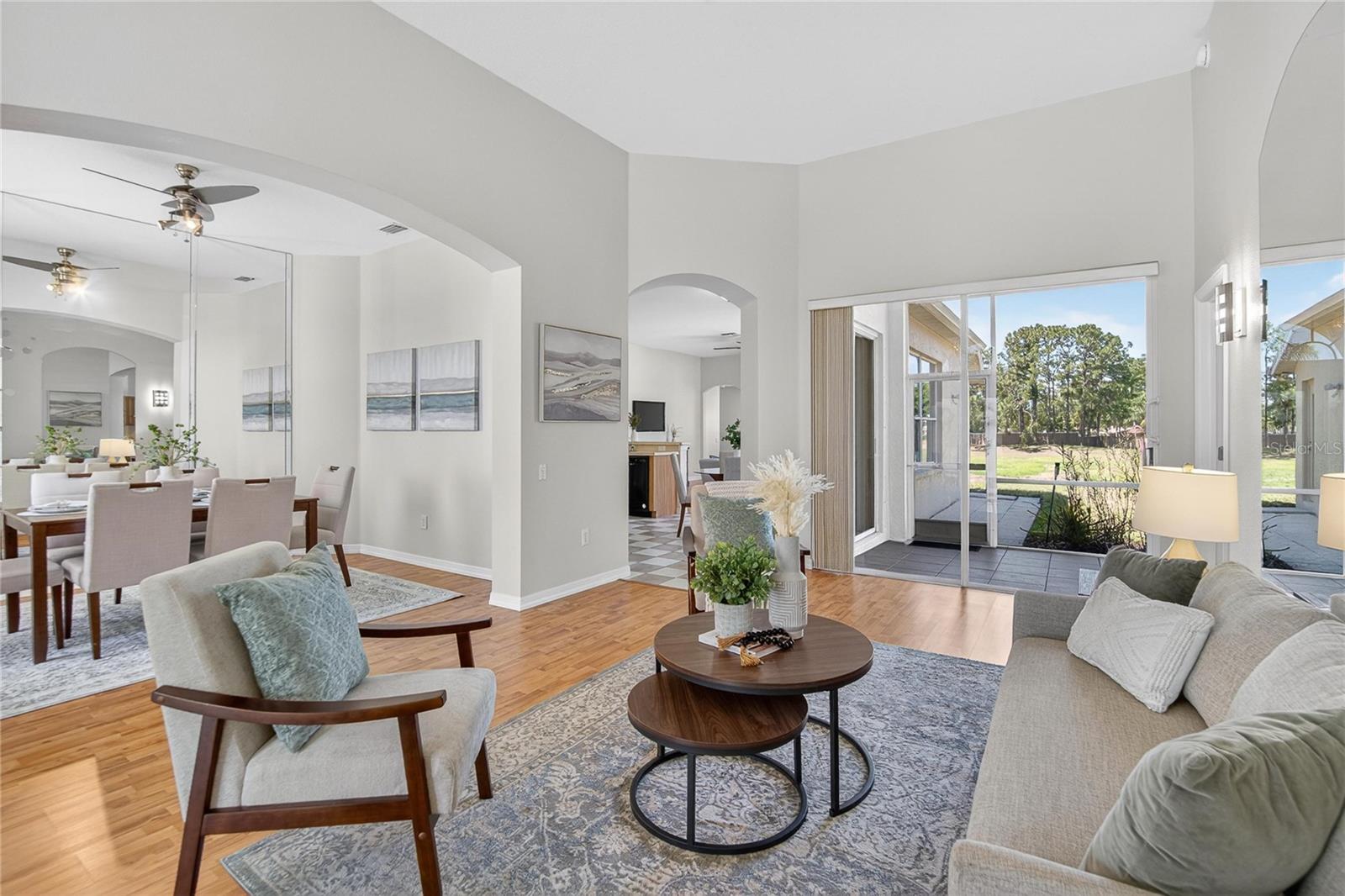 The living room overlooks a seasonal pond and a screened porch