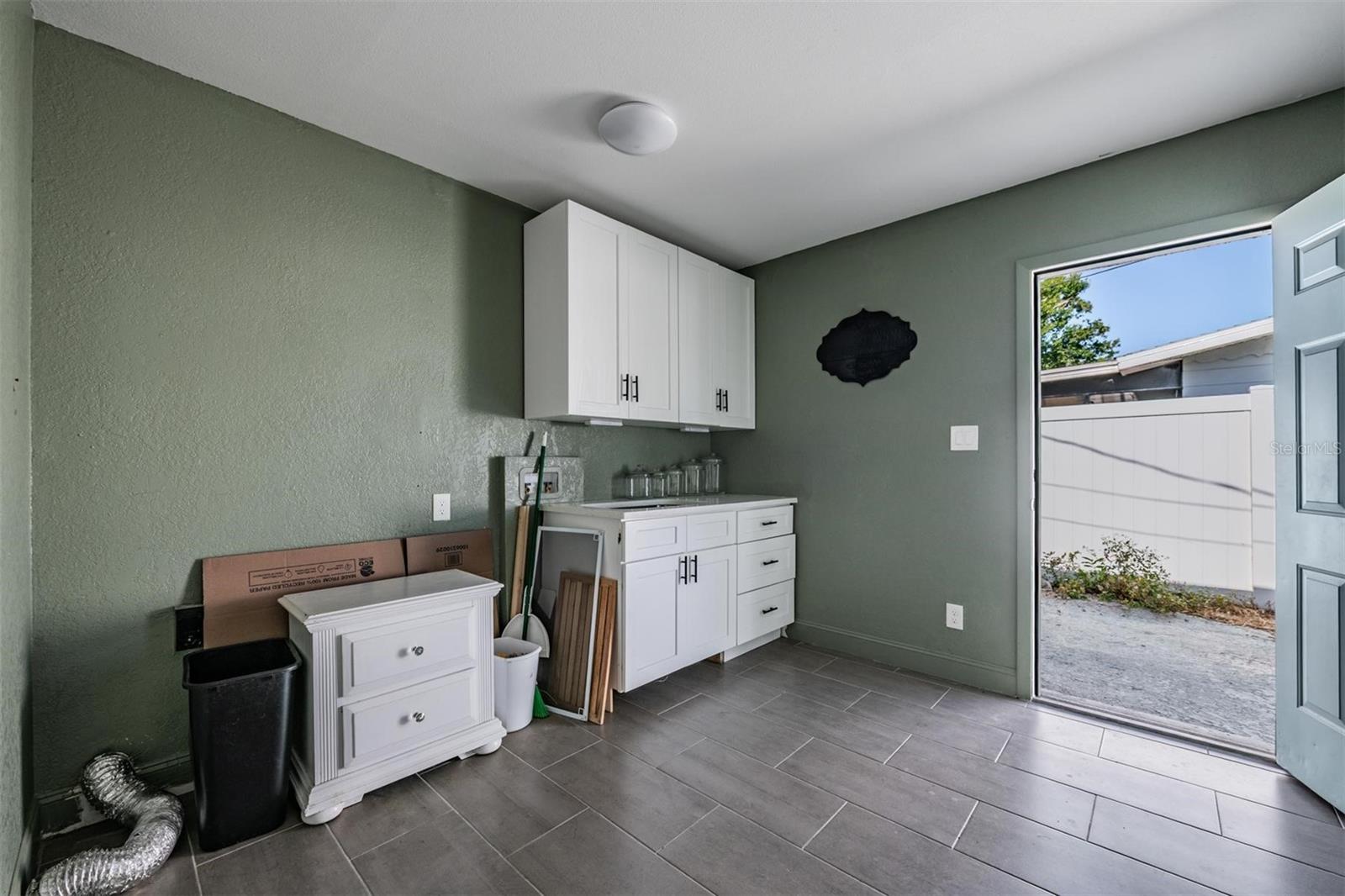 Oversized laundry room with exterior door