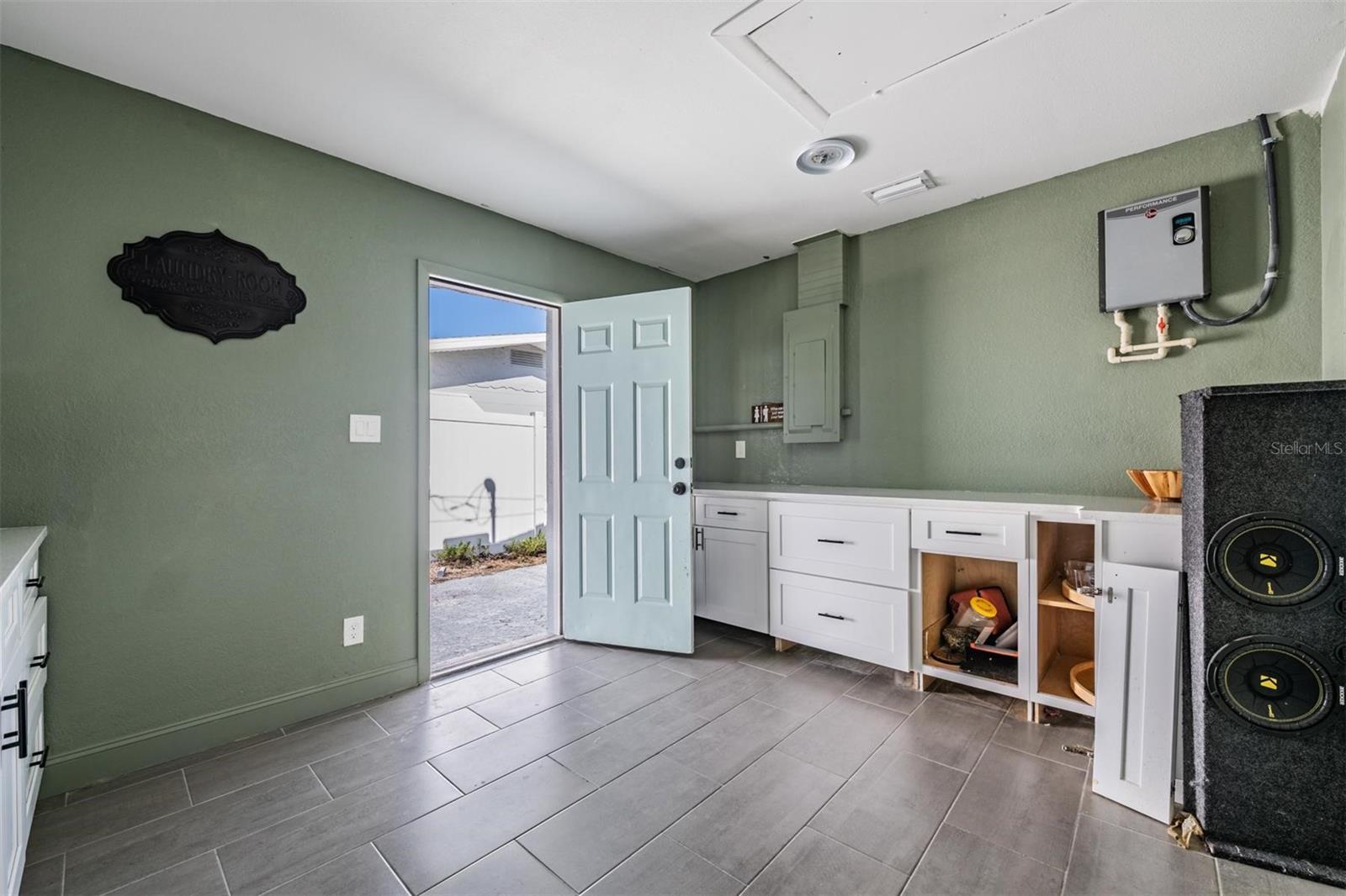 Oversized laundry room with exterior door