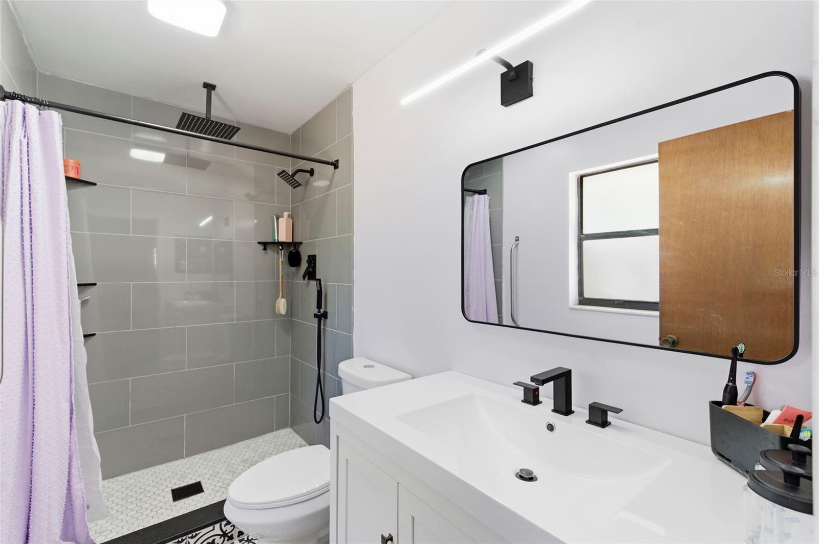Recently renovated Primary Bathroom with rain head shower.