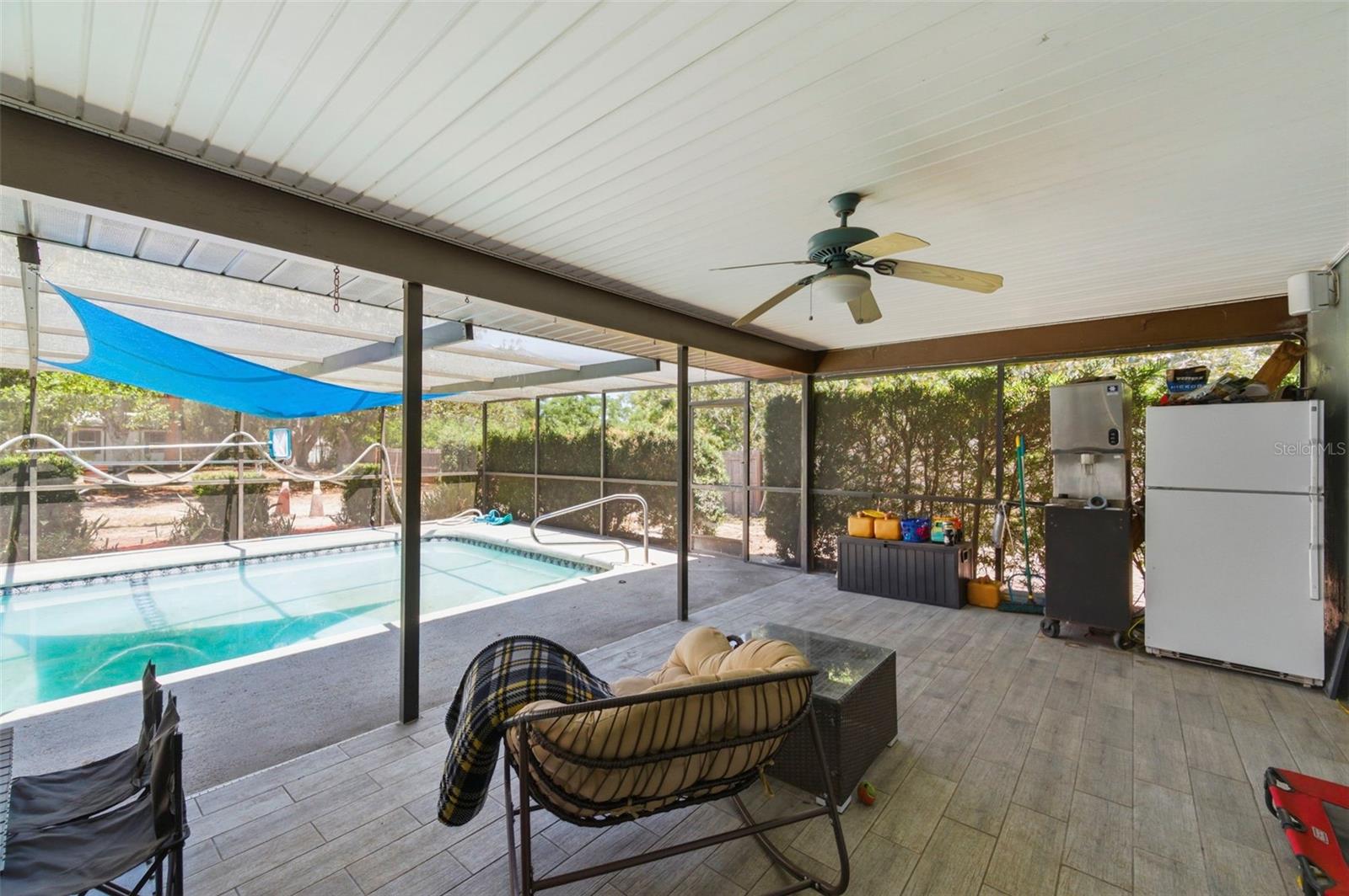 Screened Back Patio and Pool with plenty of room to relax in the shade!