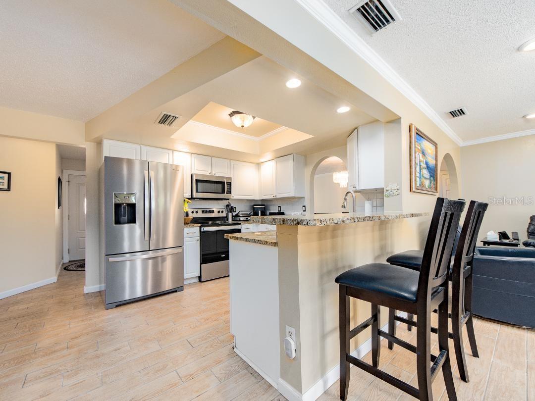 LOOKING FROM THE EATING AREA INTO THE KITCHEN.