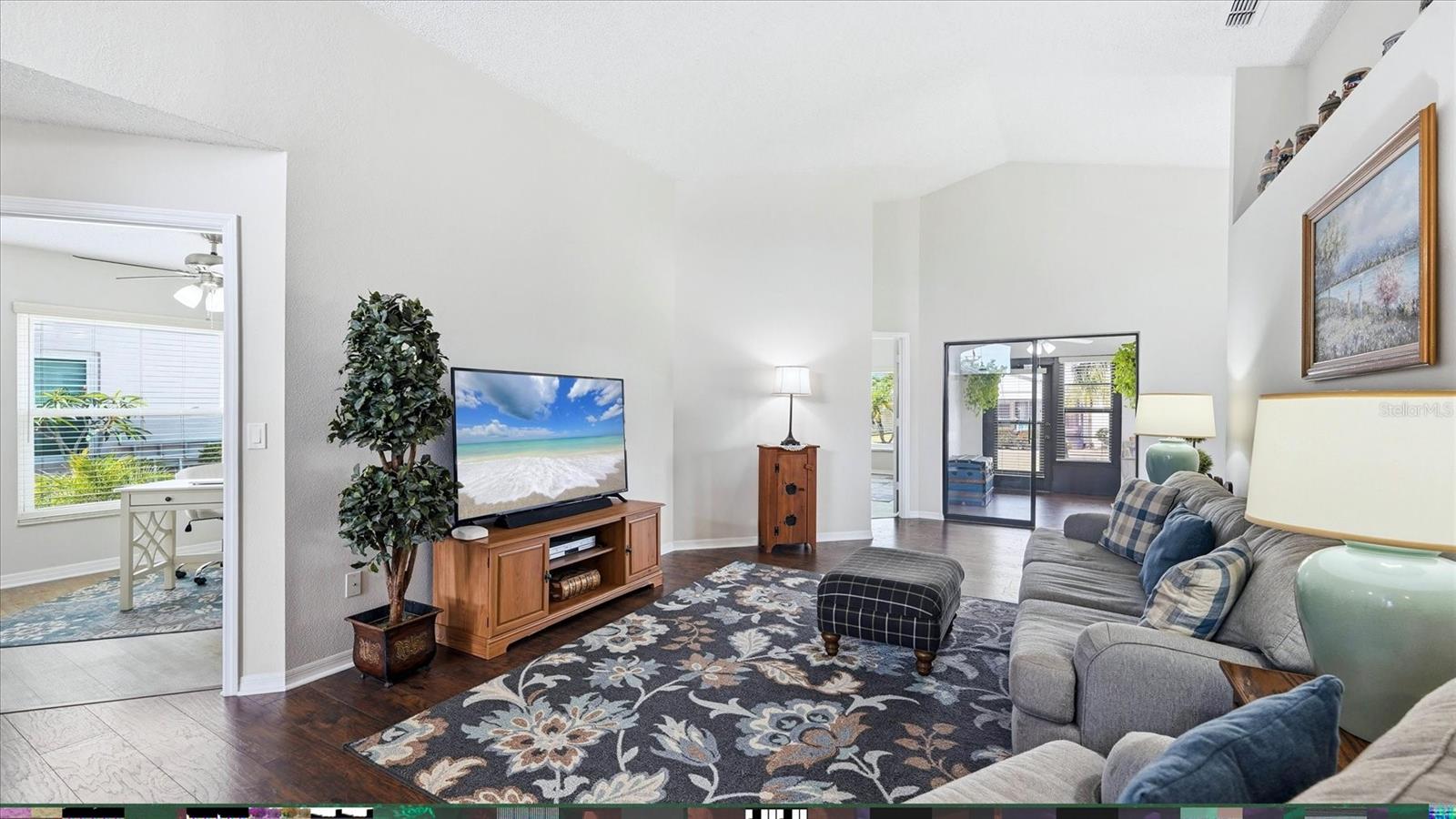 FROM THE DINNING ROOM INTO LIVING ROOM, DEN, FLORIDA ROOM