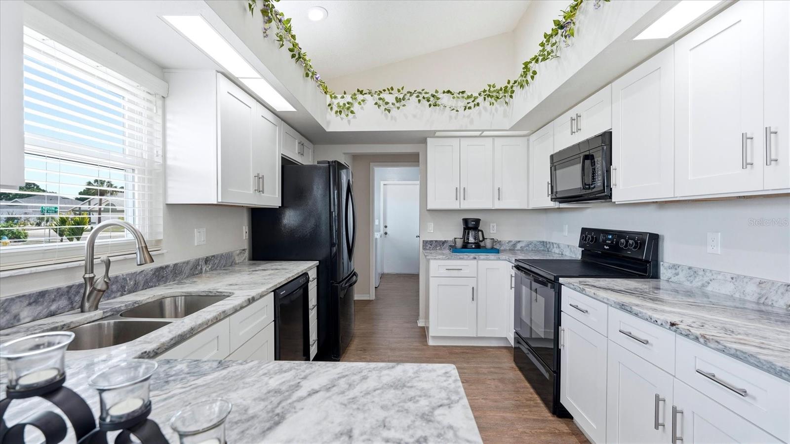 KITCHEN WITH GRANITE COUNTER TOPS AND SOFT CLOSE CABINETS AND DRAWERS
