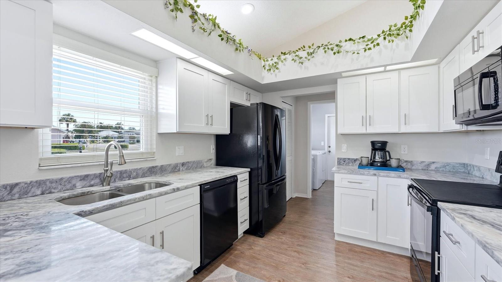 KITCHEN WITH GRANITE COUNTER TOPS AND SOFT CLOSE CABINETS AND DRAWERS