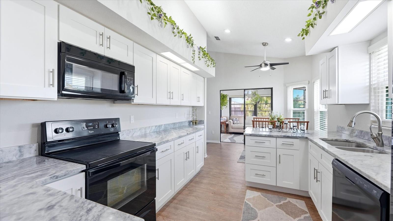 KITCHEN WITH GRANITE COUNTER TOPS AND SOFT CLOSE CABINETS AND DRAWERS