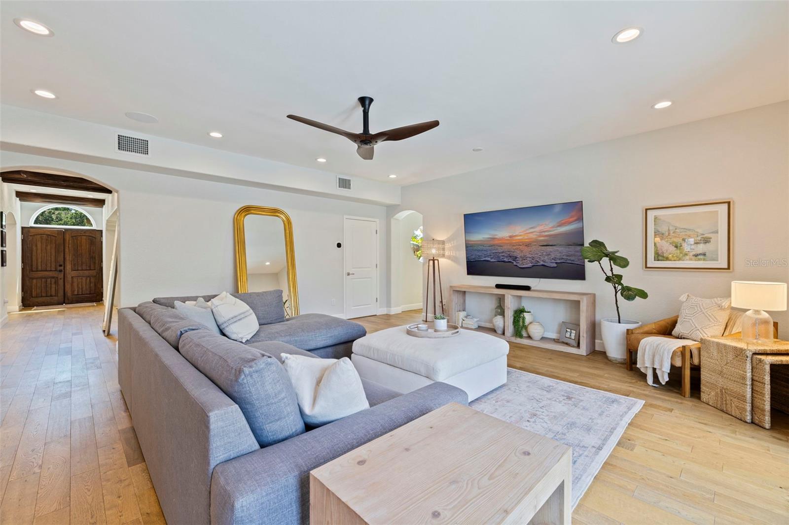 Open and spacious living room that opens up to the kitchen, courtyard, mud room and garage, and the backyard.