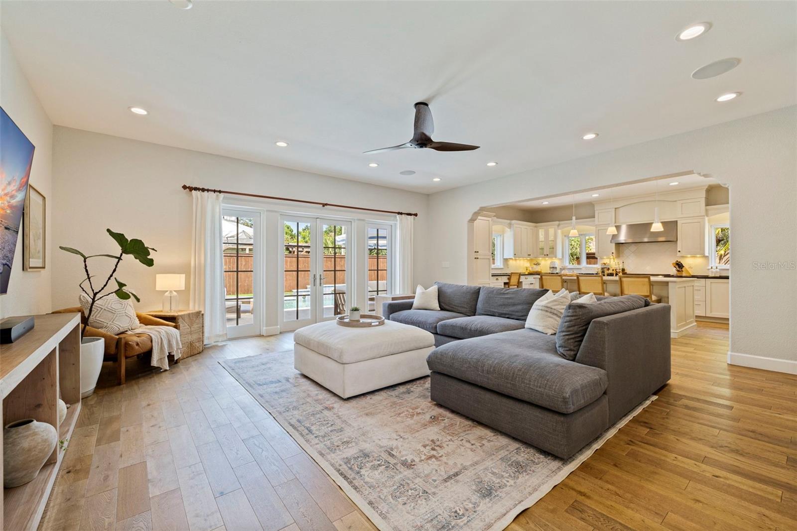 Open and spacious living room that opens up to the kitchen, courtyard, mud room and garage, and the backyard.